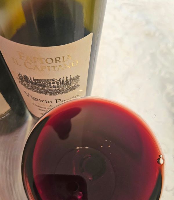 a glass of red wine next to a bottle
